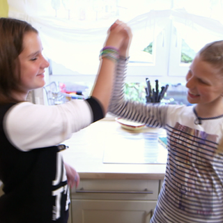 Emilie und Meri machen sich bereit zum Kochen und klatschen ab.