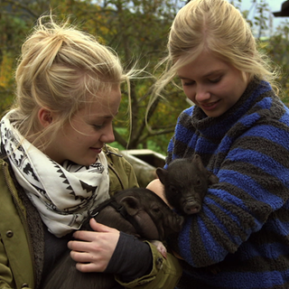 Nelly und Lilie mit Schweinchen auf dem Arm.